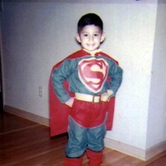 Velasquez as a child, posing dressed as Superman