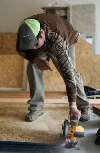 Jeff Martin of TrueSon Exteriors cuts plywood at a job site in Ashland.
