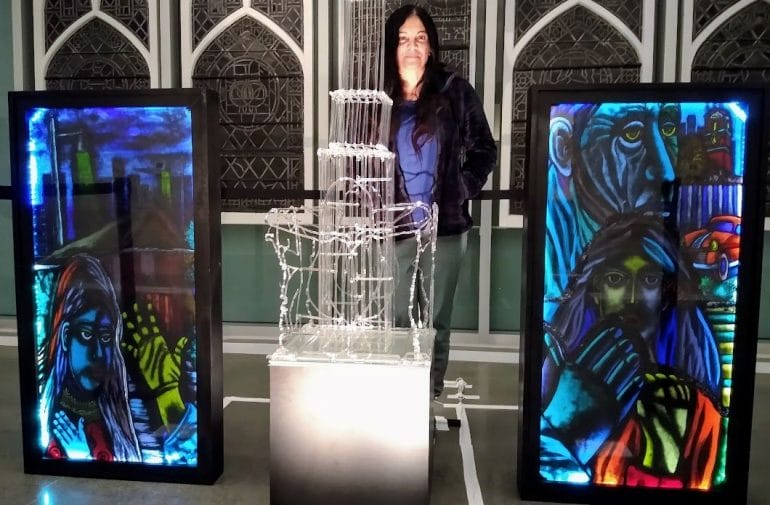 Artist Hasna Sal with a few of her glass artworks on display at the Westport Center for the Arts at Westport Presbyterian Church.