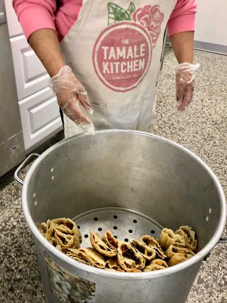 The tamales are wrapped, stacked and steamed.