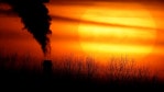In this Feb. 1, 2021 file photo, emissions from a coal-fired power plant are silhouetted against the setting sun in Kansas City, Missouri.