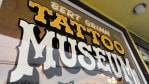 Window paint reading 'Bert Grimm Tattoo Museum'