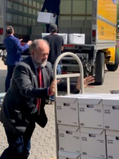 Dan Viets, chairman of the Legal Missouri 2022 advisory board, pushes boxes of petitions to legalize marijuana as they are submitted Sunday to the Secretary of State’s office.
