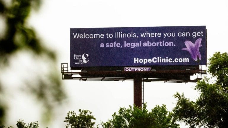 Rain pummels a billboard promoting The Hope Clinic for Women on Thursday, May 19, 2022, in East St. Louis.
