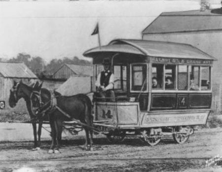 A mule car with passengers on the Walnut and Grand line at an unknown location in 1870.