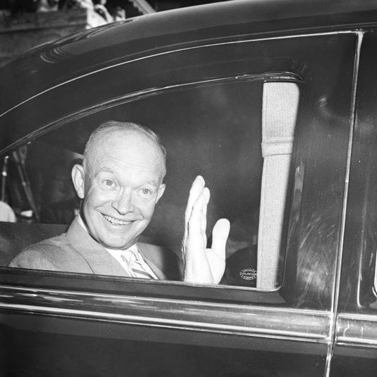 President Dwight Eisenhower displays his famous smile as he sits in his car upon leaving Walter Reed Hospital in Washington on June 30, 1956 for the drive to his Gettysburg farm.