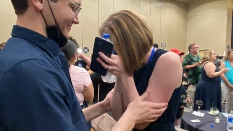 Jae Gray, right, a field organizer in Johnson County for campaign opposing the amendment, is overcome with emotions after the race was called.