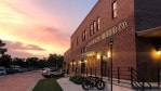 The exterior of Lawrence Beer Co. with the sunset in the background.