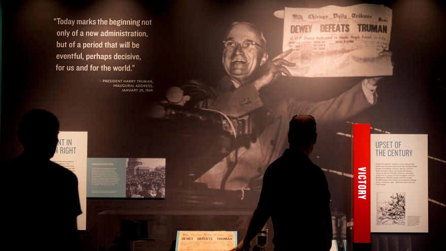 People view an exhibit about the 1948 presidential election during a tour of the Harry S. Truman Presidential Library and Museum. The facility reopened after a nearly $30 million renovation project.