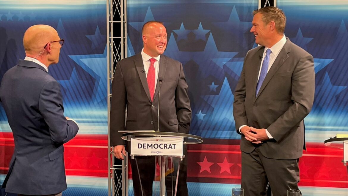 Debate moderator Nick Haines of Kansas City PBS visits with Kansas attorney general candidates Chris Mann (middle) and Kris Kobach (right).
