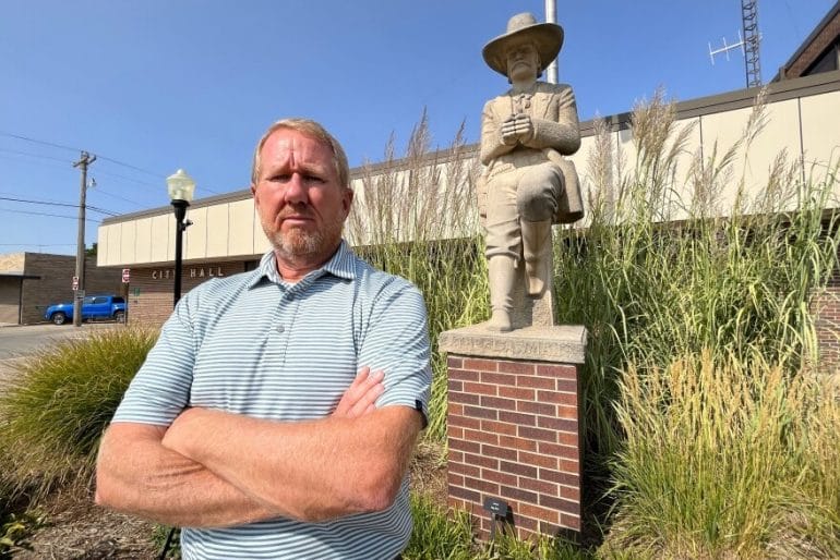 Hays City Manager, Toby Dougherty, stands in the middle of a drought-tolerant demonstration garden in front of Hays City Hall. The city has planted gardens like this throughout town to show residents which plants can work in this environment.
