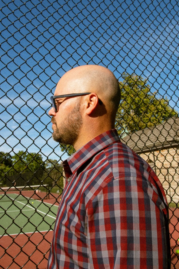 Jose Martí is an electrical engineer by trade and president of the Puerto Rican Society of Great Kansas City by night and weekends. Standing in front of a tennis court is a callback to his father. They'd agreed to get their minds off the hurricane on the court. (Ji Stribling | Flatland)