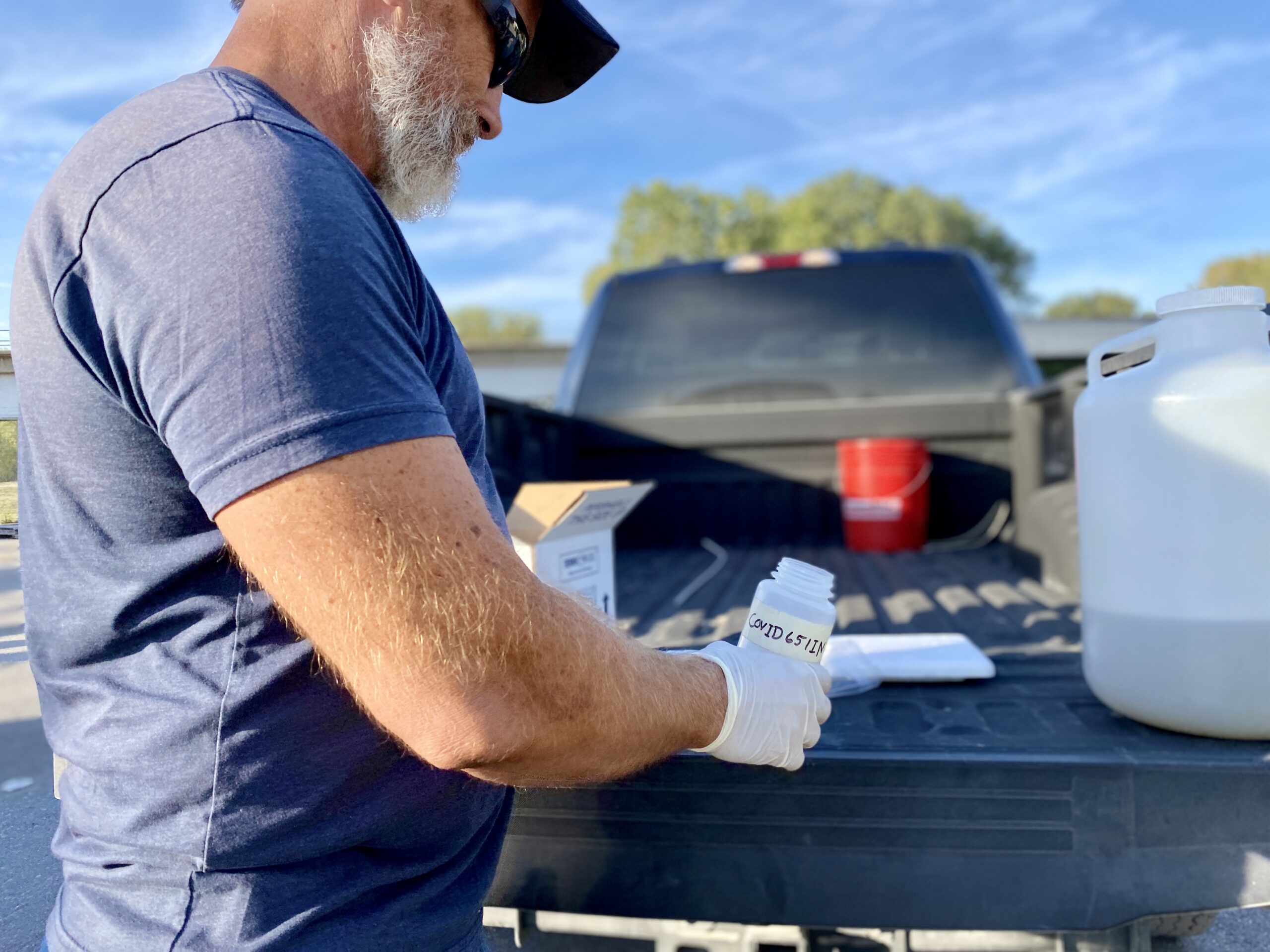 Scott Goins, KC Water's senior plant operator preps the testing bottle that will be shipped back to the lab in Columbia, Missouri. (Vicky Diaz-Camacho | Flatland)