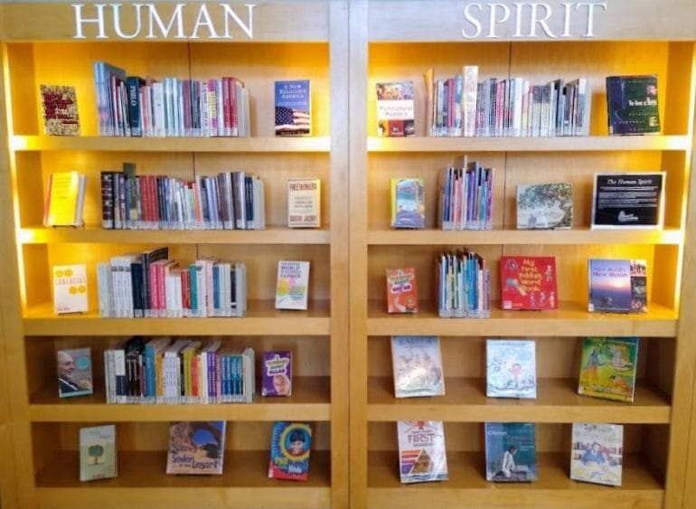 This double display case at the Country Club Plaza branch of the Kansas City Public Library holds books provided to the library by an interfaith group called Cultural Crossroads.