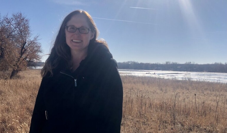 Liz Elliott stands near the Platte River, one of the sources of Lincoln's drinking water. Elliott is on a team that's seeking another source after the current drought has at times left little water in the river.