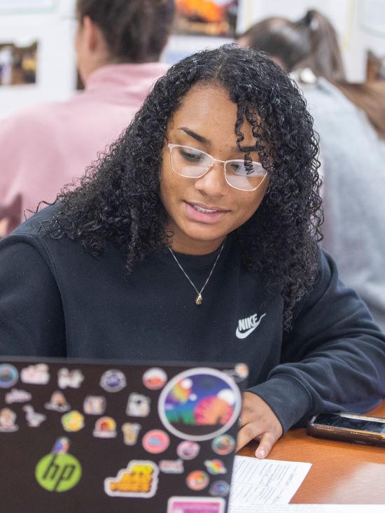 A college student with a laptop.