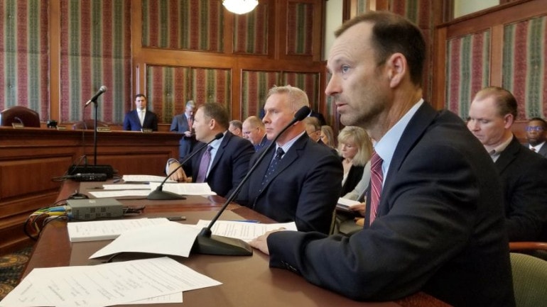 Bill DeWitt III, president of the St. Louis Cardinals, foreground, testifies in favor of sports wagering alongside Todd George, executive vice president of Penn National Gaming, center, and Jeremy Kudon, president of the Sports Betting Alliance.
