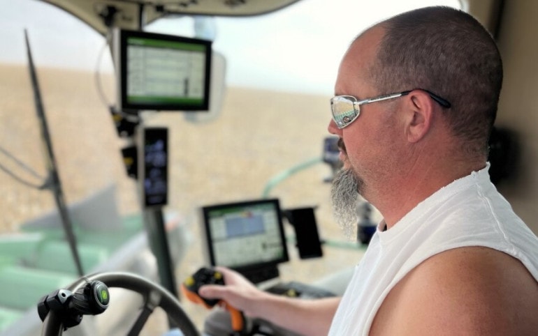 Brian Bauck drives his combine harvester across one last corn field to end the season. The drought has made this an especially tough year, but he's found ways to make it work, even with less irrigation.