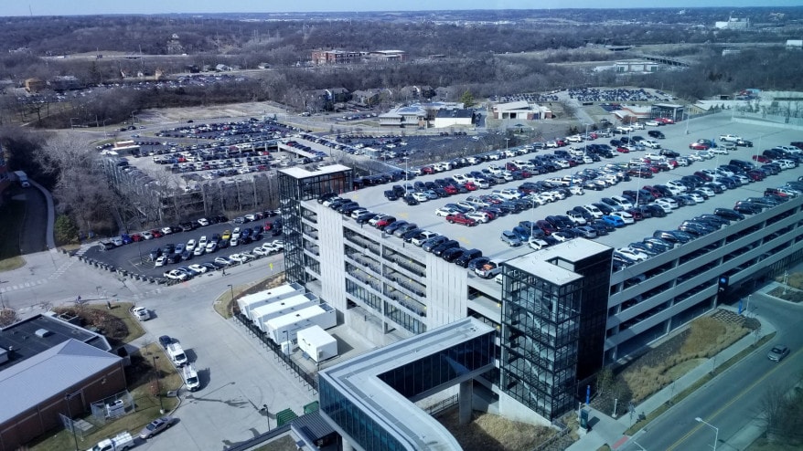 This view, looking northwest, shows the site of the KU Cancer Center’s proposed new building. The plan is to place the building between the two parking structures.