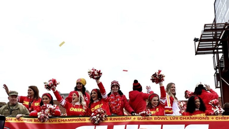 Team cheerleaders wave to the crowd from atop a bus in the Kansas City Chiefs Super Bowl championship parade.