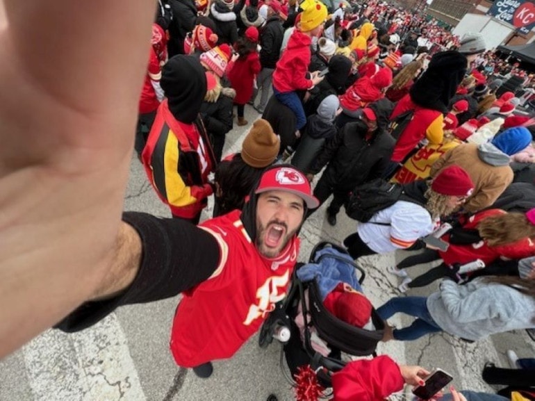 Cole Blaise, director of production at Kansas City PBS, captures a selfie amid the crowd at the Kansas City Chiefs Super Bowl championship parade.