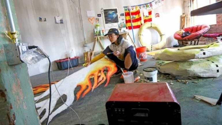 Artist Noelle Choy works on faux flames for a dog throne at her studio in the Holsum building.