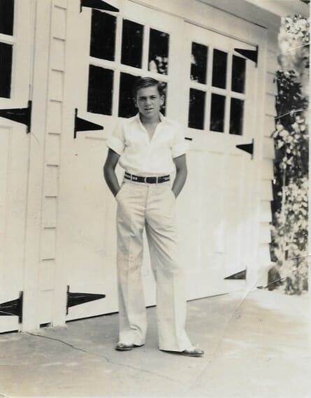 High school football player John McKee standing outside of a parking garage at his home.