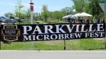 Entrance sign for the Parkville Microbrew Fest with English Landing Park in the background.