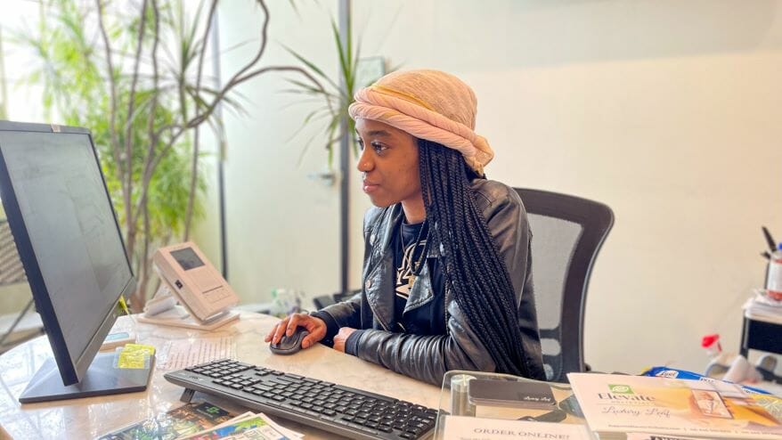 Dierra Henderson, a budtender at Luxury Leaf dispensary in St. Louis, checks in clients at the front door.
