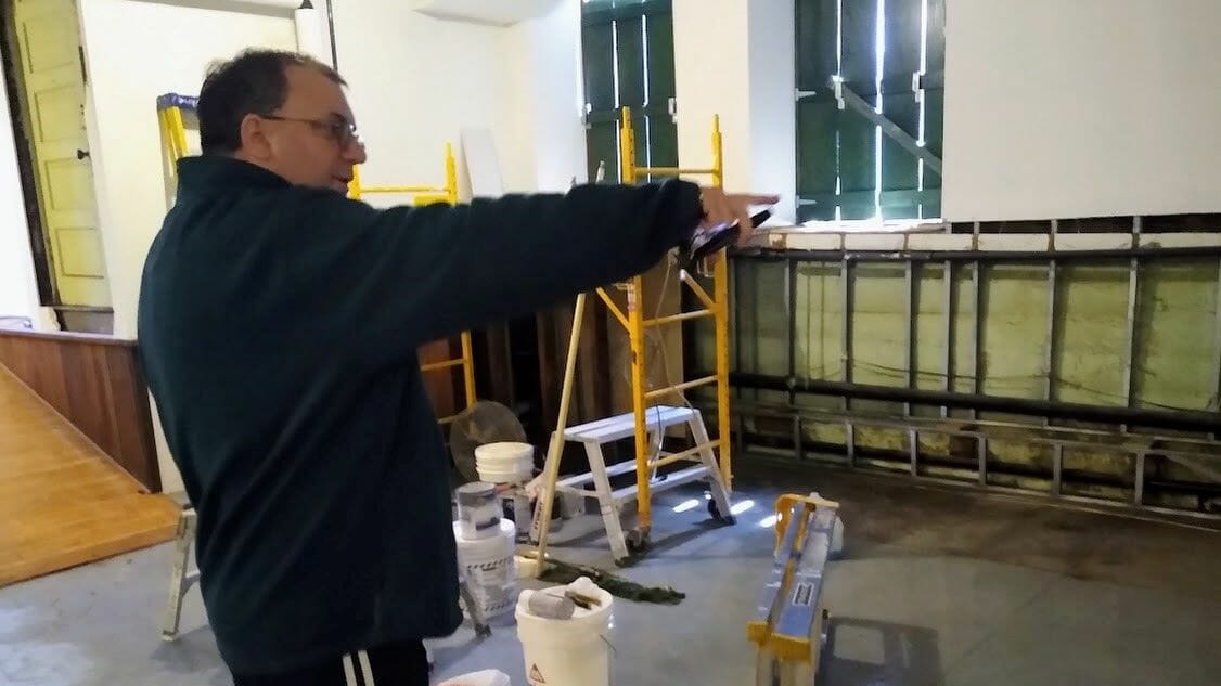 Deacon Jude Huntz checks on the lower-level reconstruction project at the Christ the King church building.