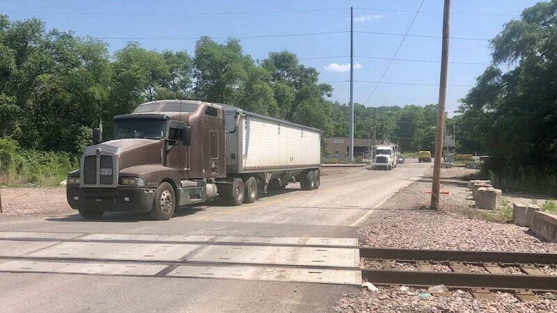 A truck crossing railroad tracks on Lydia Avenue.