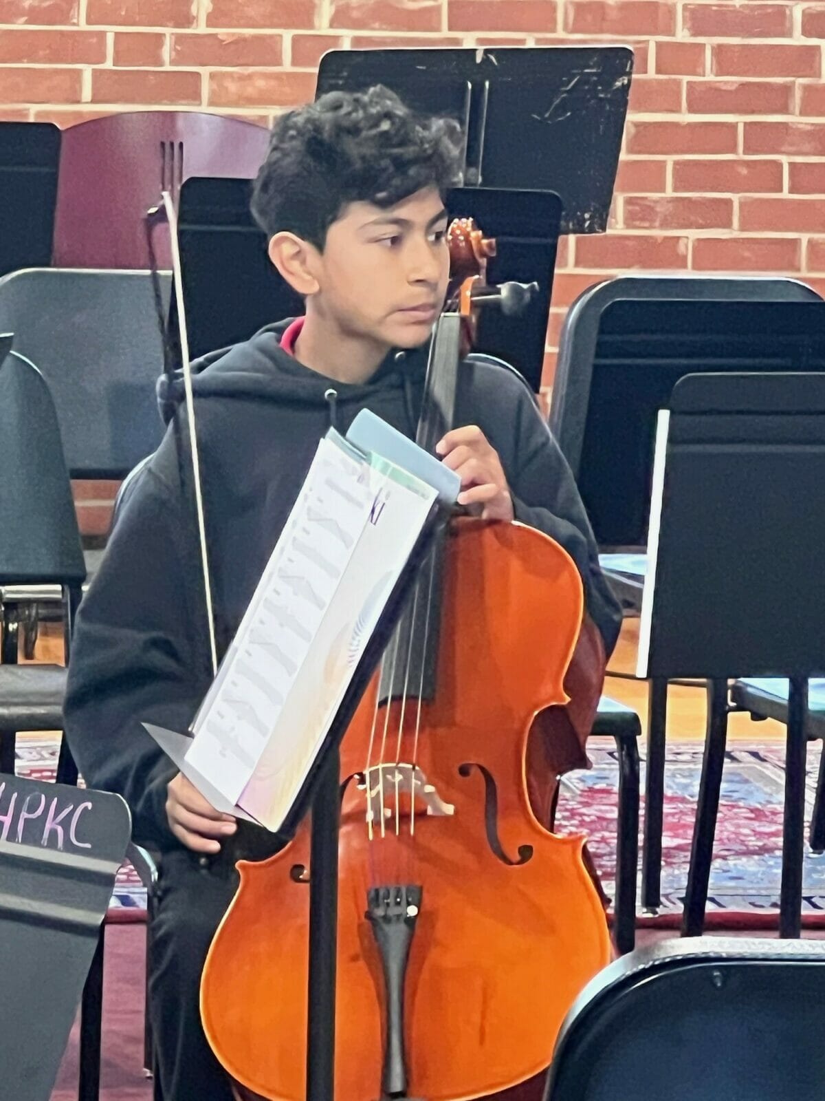 A boy plays the cello.