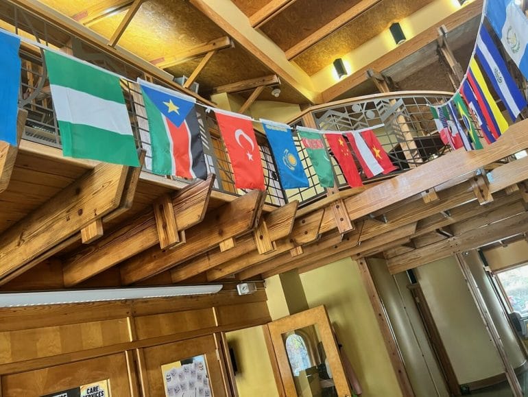 Some of the 29 national flags hanging in the Northeast Community Center.