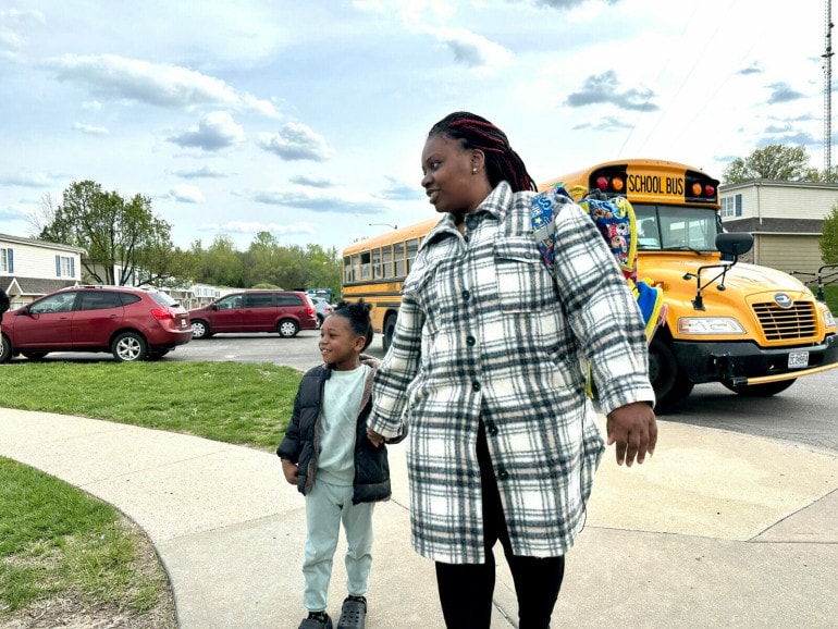 Jasmaine Colbert greets her son after school. She's been a resident at Blue Valley Court Townhomes for nearly nine years but has wanted to move after her son was diagnosed with lead poisoning. (Vicky Diaz-Camacho | Flatland)