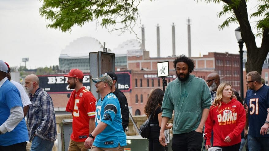 Fans decked out for the NFL Draft walk around Washington Square Park Thursday on their way toward Union Station and the NFL Draft event grounds.