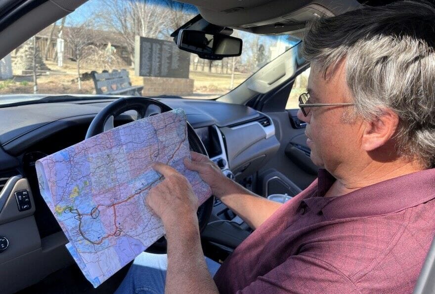 Lee Veeser points to his map outlining the route he and his wife are taking across Kansas during their road trip.