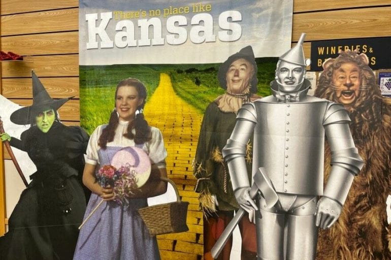 Cardboard version of characters from the Wizard of Oz film greet travelers inside the Kansas welcome center on Interstate 70 near Kanorado. The banner in the background features the state's former tourism slogan, there's no place like Kansas.
