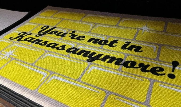 A welcome mat in the Liberal museum gift shop entices shoppers to tell more people that they aren't in Kansas anymore.