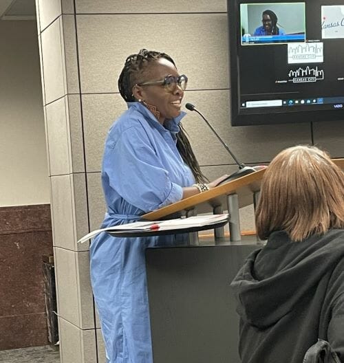 Stephenie K. Smith stands at a podium to testify before the Kansas City Charter Review Commission.