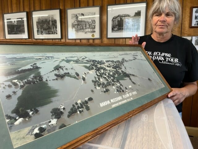 Cathy Gottsch, Ray County Museum administrator, holds an aerial photo of the 1993 flood.