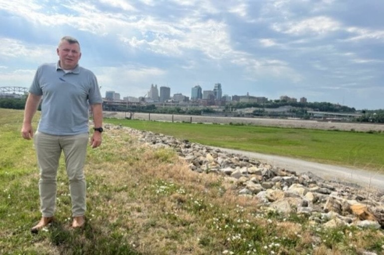 Jud Kneuvean stands atop the levee next to the Missouri River at the downtown airport.