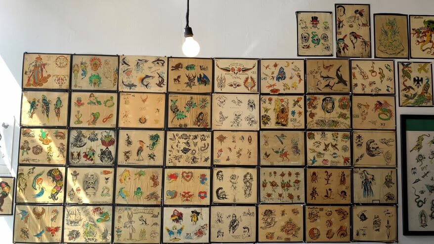 A wall of tattoo designs.