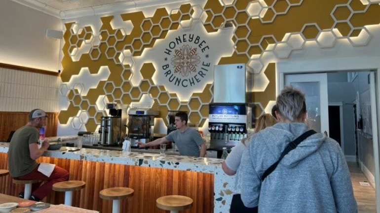 Inside the Honeybee Bruncherie in Humboldt, which features a honeycomb design feature behind the counter.