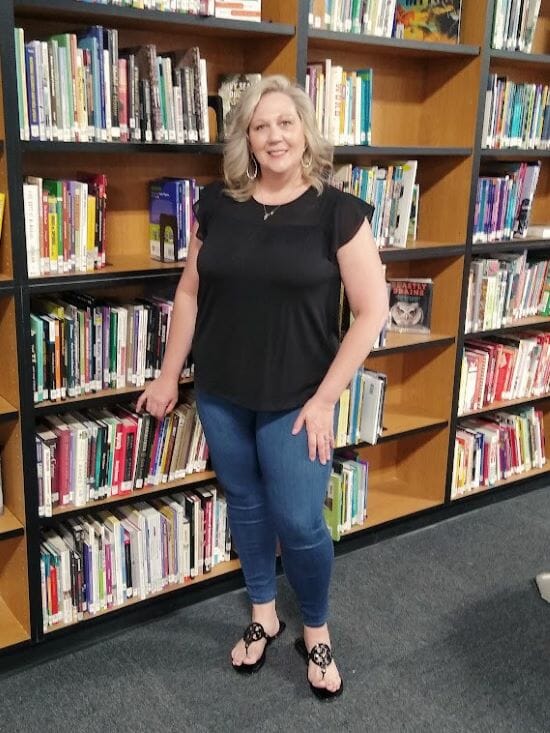 Angela Gottesburen in the library at Lone Jack High School.