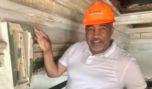 Allan Gray, co-developer of the Zhou B. Art Center, points to the initial of former Attucks School above the auditorium stage now being renovated.