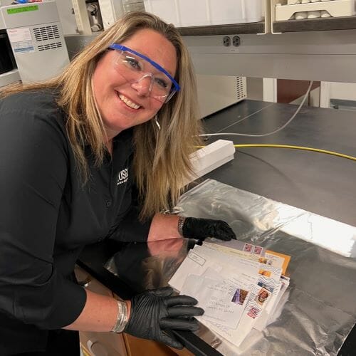 Julie Dietze with the day’s mail of deceased butterflies for her landmark study of what is threatening the population of butterflies and insects.
