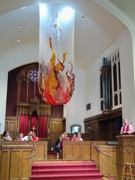 This large fabric art that celebrates Pentecost in the Christian tradition hangs in the sanctuary of Second Presbyterian Church of Kansas City for several weeks each spring. It’s the work of Second choir member Sharon Betzelberger, who is seated in the middle of the front row on the choir on the left.