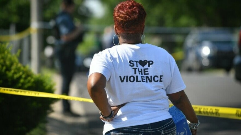 A woman wearing a "Stop the Violence" T-Shirt.