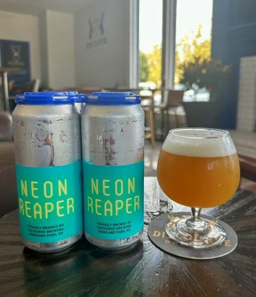 Discourse Brewery's Neon Reaper in cans and a glass.