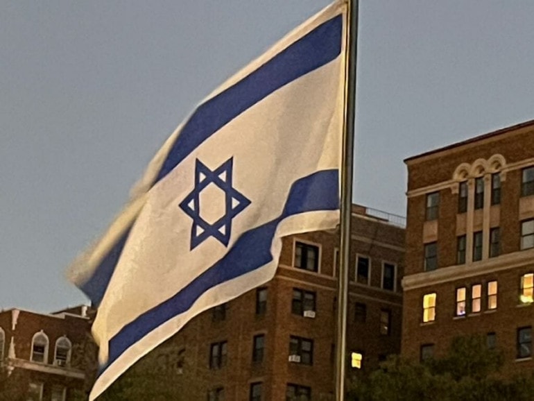 The Israeli flag is among those displayed on the Sister Cities International Bridge over Brush Creek.